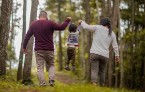 Canva Man and Woman Carrying Toddler